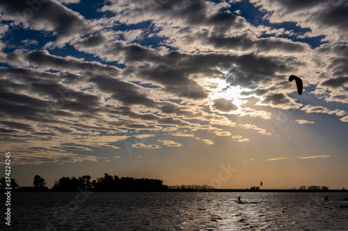 silhouette of a man windsurfing on the beach