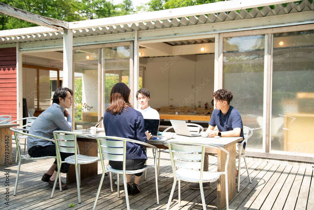 Men and Woman Having a Meeting on an Outdoor Office that Set Social Distancing as New Normal Office Style Men and Woman Having a Meeting on an Outdoor Office that Set Social Distancing as New Normal Office Style