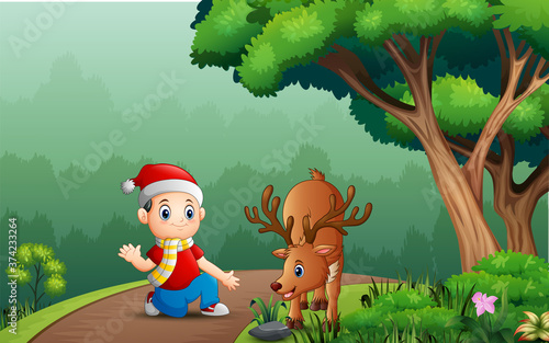 Little boy with a deer in the forest