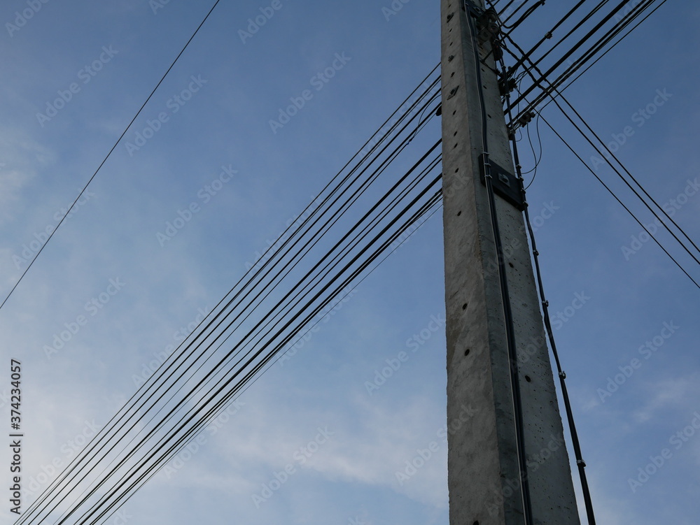 Naklejka premium electric pole with wires in the sky.