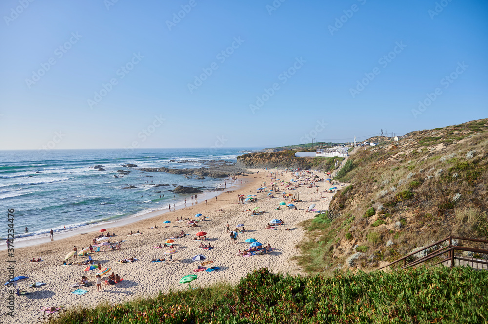 Alentejo beach of almocreve with people on a summer day