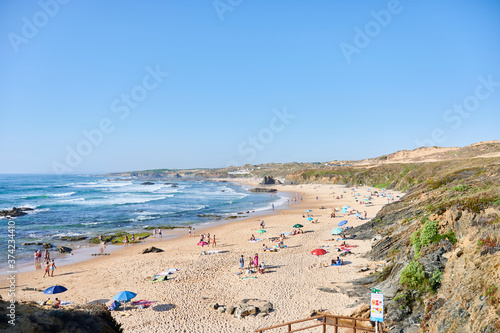 Almograve beach with people on summer day photo