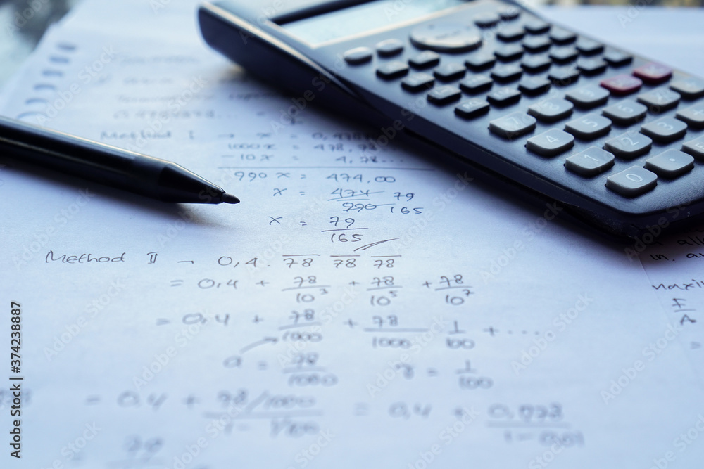 scientific math workout. sheet paper with solving equation math next to calculator scientific math workout. sheet paper with solving equation math next to calculator