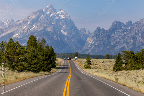 Road Heading Into The Grand Teton Mountains In Wyoming 