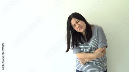 Young asian woman suffering from abdominal pain , woman having a stomach ache