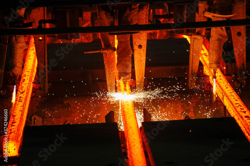 Steel billets at torch cutting in metallurgical plant. Metallurgical production, heavy industry, engineering, steelmaking