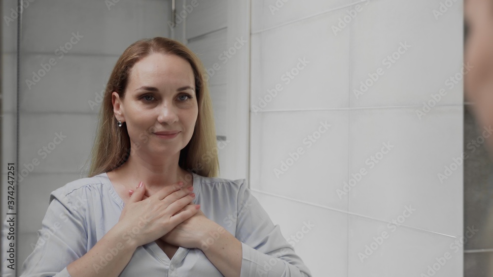 Adult woman looking in mirror enjoy natural beauty and healthy Adult woman looking in mirror enjoy natural beauty and healthy