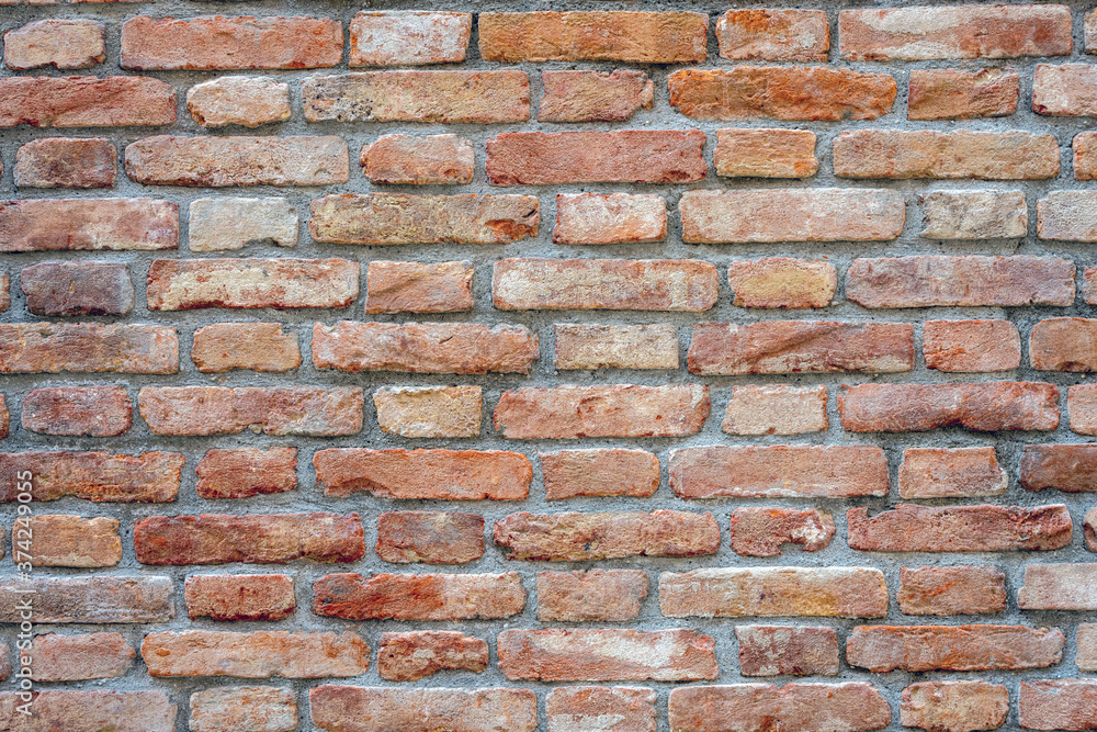 Obraz premium Background from an old and worn red brick wall