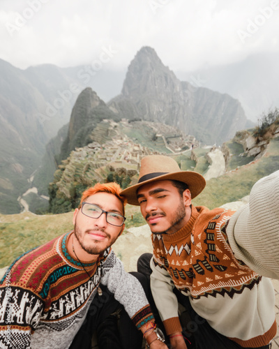 Gay couple in Machu Picchu Peru taking a selfie photo