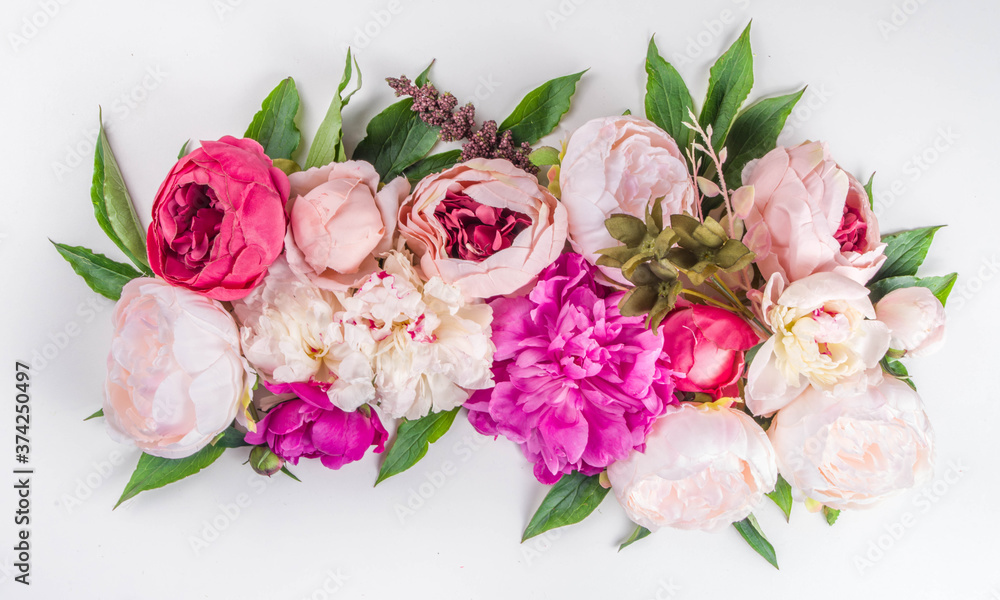 Flat lay of flowers and green leaves