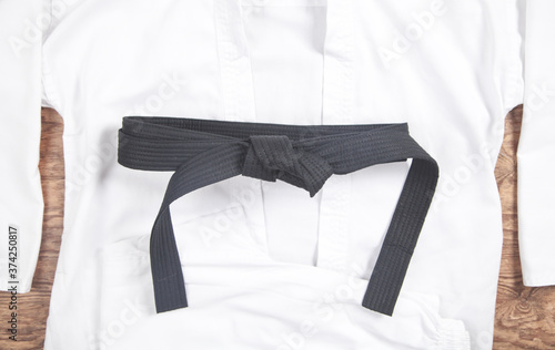 Martial arts clothes. Karate uniform with black belt photo