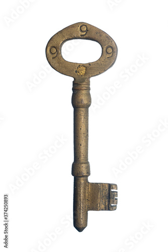 antique golden door key isolated on white background. close up