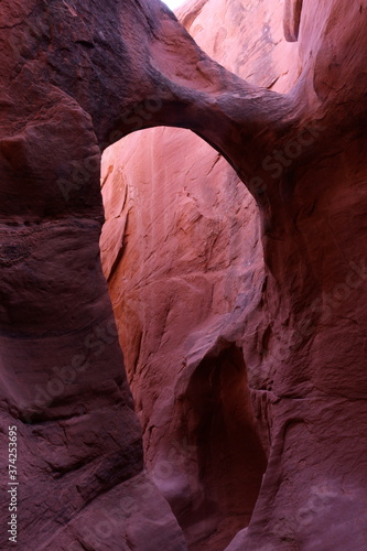 The arched entrance to Peekaboo Slot Canyon in Grand Staircase Escalante National Monument, Utah. photo