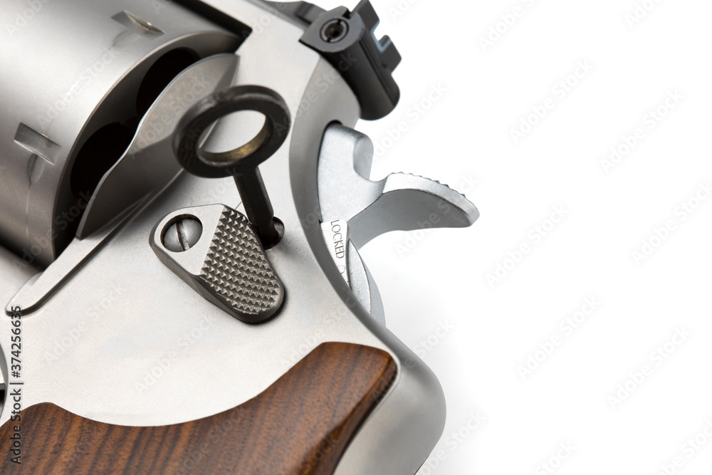 Securing the revolver gun with the key on white background