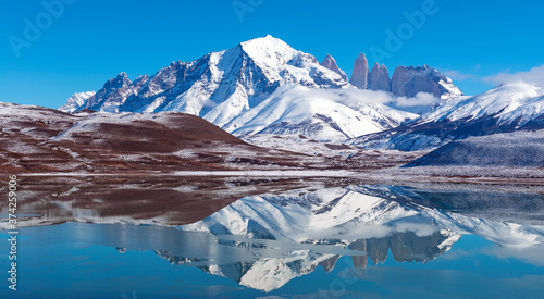 Panoramic reflection of the Torres del Paine granite peaks in winter with copy space, Torres del Paine national park, Patagonia, Chile.
