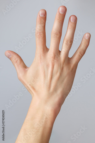 Man hand shows the number five. Countdown gesture or sign. Sign language.