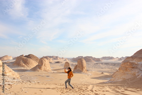 young woman walking in desert