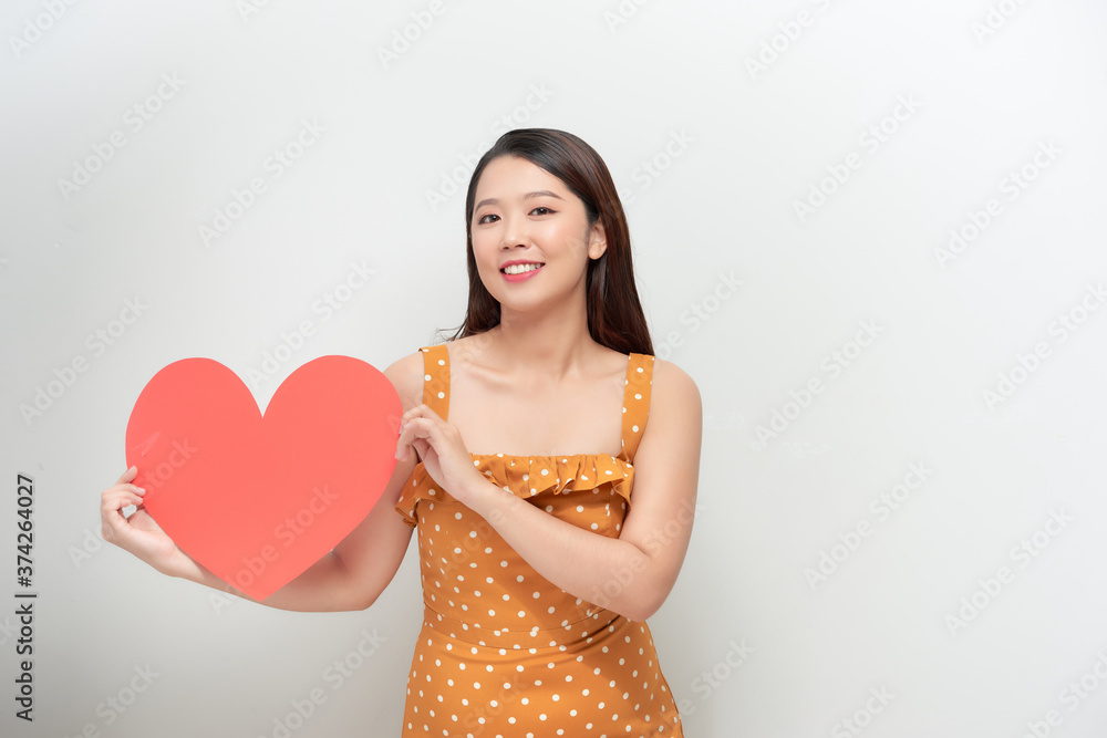 Woman holding big red heart on white background Woman holding big red heart on white background