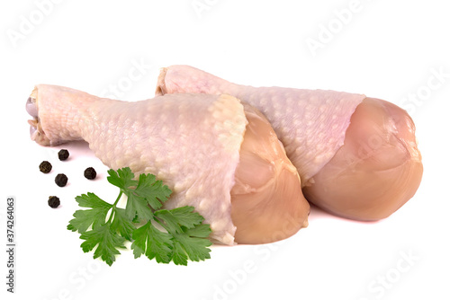 Raw chicken legs with parsley isolated on white background