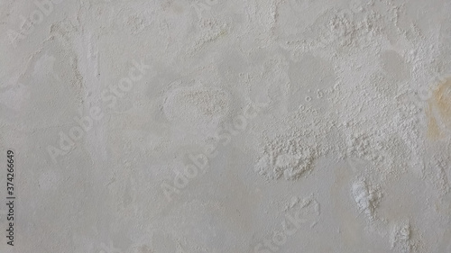 A picture of a white plaster wall that has decayed from the water entering the exterior cracks.