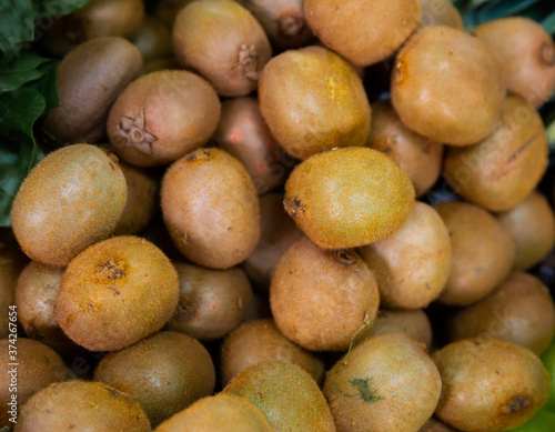 Ripe kiwi fruits in box for sale in greengrocery