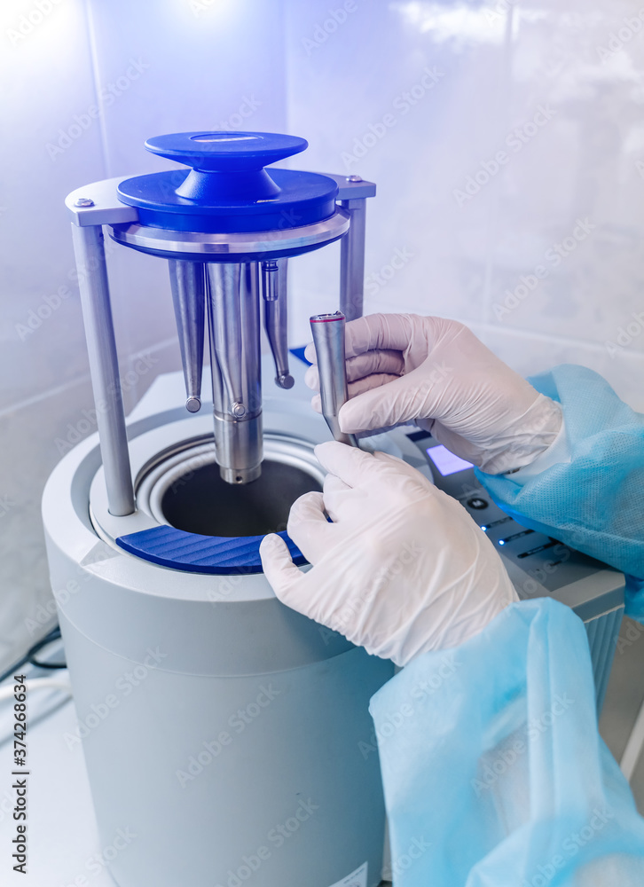 Female nurse doing sterilization of dental medical instruments in