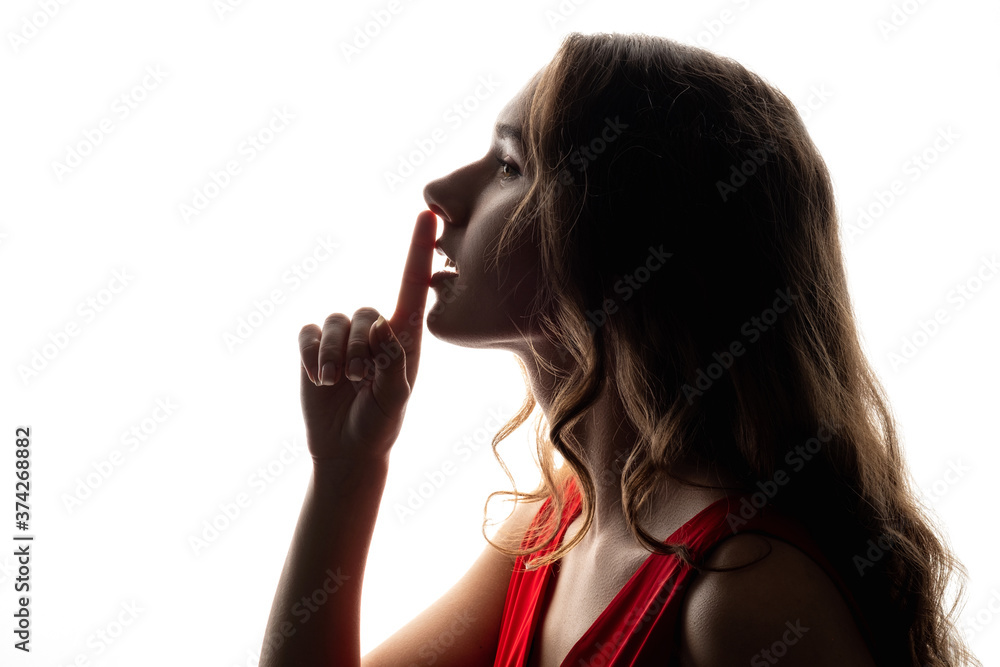 Woman secret. Stop talking. Peaceful lady showing shhh gesture with finger at lips isolated on white copy space background. Gossip mystery. Silent beauty. Female profile silhouette. Taboo sign. Woman secret. Stop talking. Peaceful lady showing shhh gesture with finger at lips isolated on white copy space background. Gossip mystery. Silent beauty. Female profile silhouette. Taboo sign.