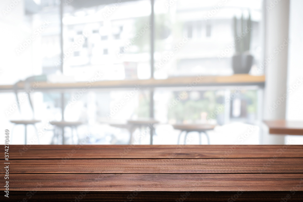 Empty wooden desk space and blurry background of cafe or Restaurant for product display montage Empty wooden desk space and blurry background of cafe or Restaurant for product display montage