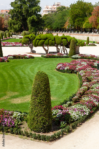 Beautiful Park with a lot of green trees and bushes in Madrid, Span in September during the sunny day
