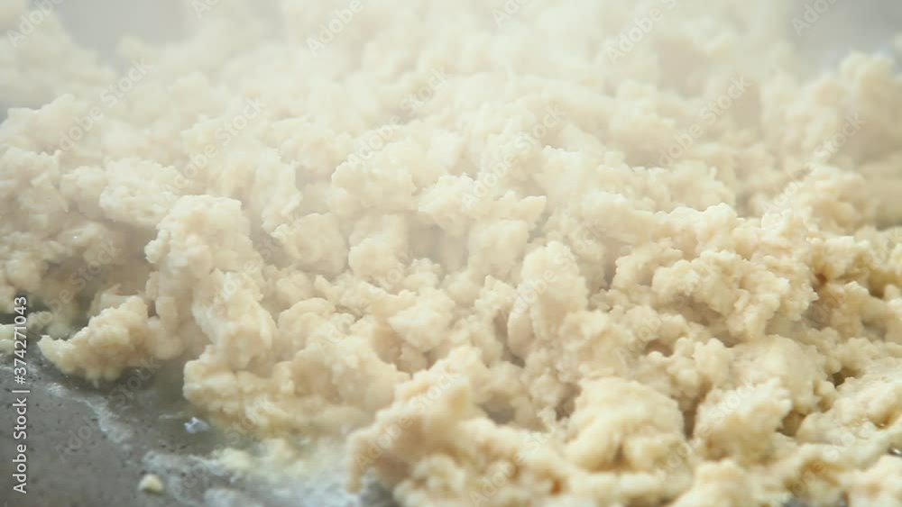 Frying minced chicken in pan, in door Chiangmai Thailand Frying minced chicken in pan, in door Chiangmai Thailand