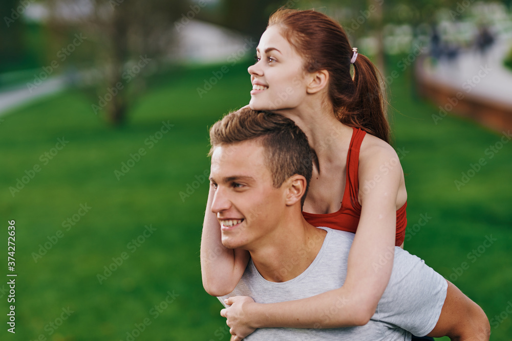 woman on back men outdoors walk fun lifestyle woman on back men outdoors walk fun lifestyle