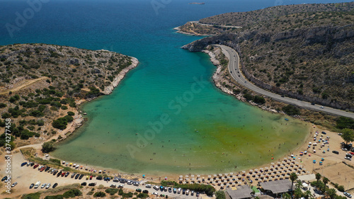 Aerial drone photo of small protected by winds cove and sandy beach of Lomvarda in Athens riviera next to Hole of Karamanlis tunnel, Vouliagmeni, Attica, Greece photo