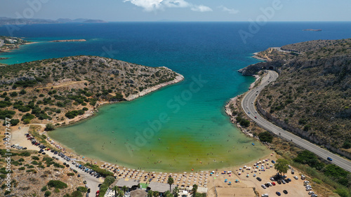 Aerial drone photo of small protected by winds cove and sandy beach of Lomvarda in Athens riviera next to Hole of Karamanlis tunnel, Vouliagmeni, Attica, Greece © aerial-drone