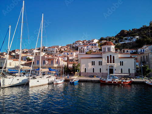 Scenic view of Poros island in a typical summer day. Old town with traditional white houses near the sea. Saronic gulf, Greece, Europe.