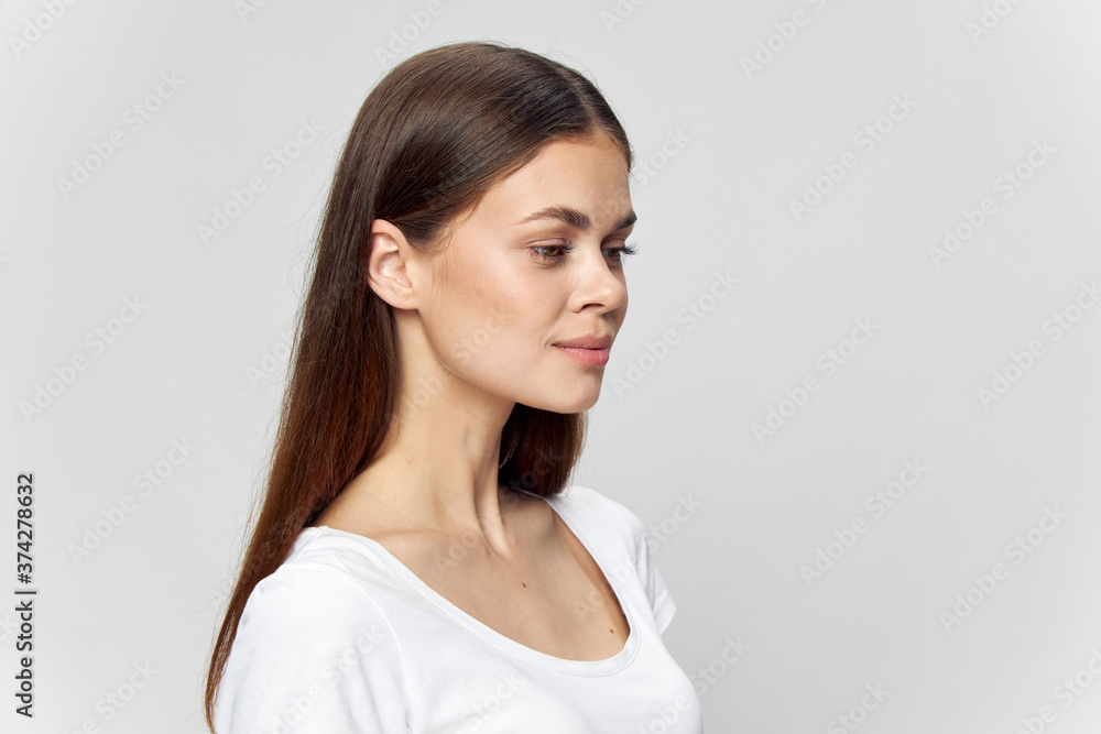 Girl in a white T-shirt on an isolated background beautiful face naked neck Copy space Girl in a white T-shirt on an isolated background beautiful face naked neck Copy space