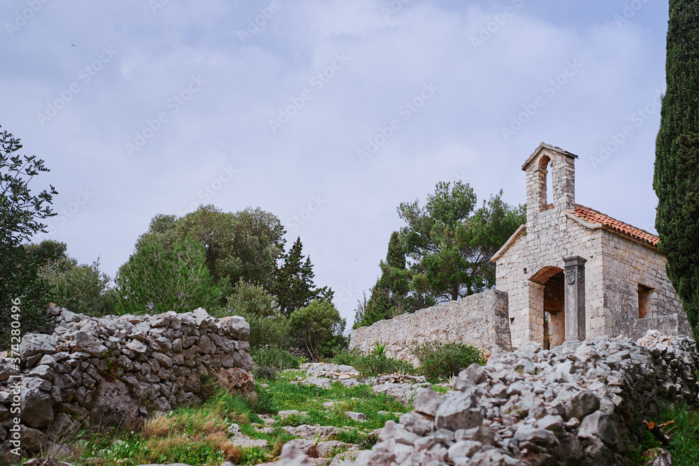 Ancient small catholic chapel made from stones with tiled roof. Ancient small catholic chapel made from stones with tiled roof.