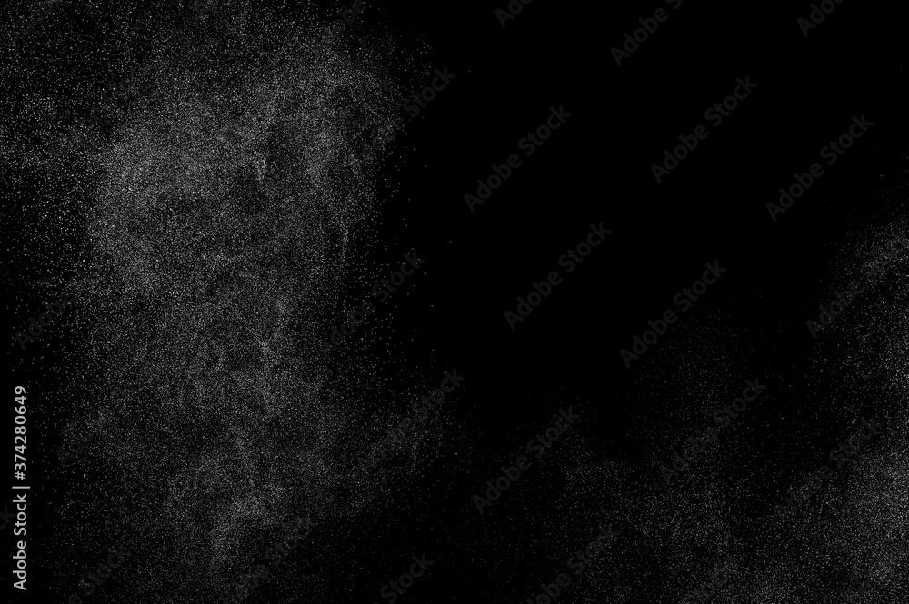 Abstract splashes of water on black background. Freeze motion of white particles. Rain, snow overlay texture. Abstract splashes of water on black background. Freeze motion of white particles. Rain, snow overlay texture.
