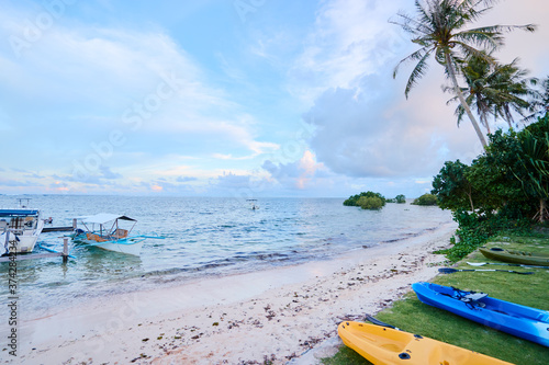 Colorful kayaks on the beach of island in Philippines. Tropical vacation and travel. Active tourism.