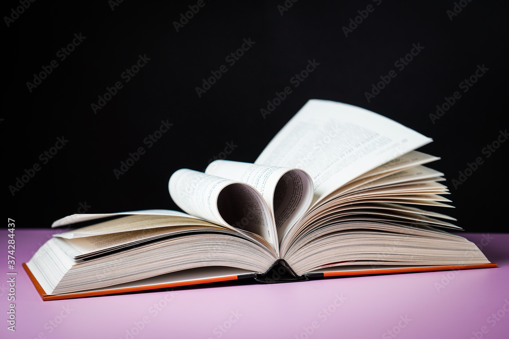 Fototapeta premium Open book on the table. It is time for education and therefore you need to go back to school.