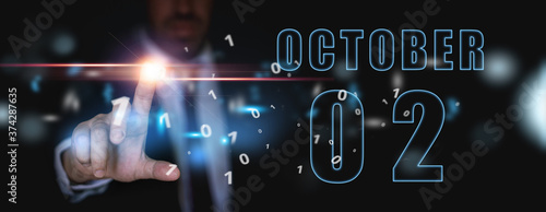 october 2nd. Day 2 of month, announcement of date of business meeting or event. businessman holds the name of the month and day on his hand. autumn month, day of the year concept