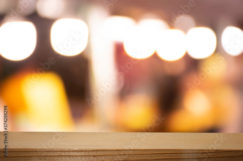 Product display on brown wooden table Bokeh background from the bulb shop