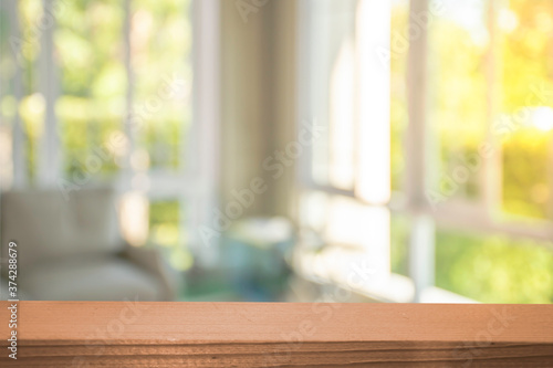 Display products on a brown wooden table in a bright white room in the morning