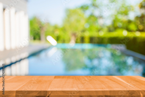 Product show On a brown wooden table Outdoor swimming pool area