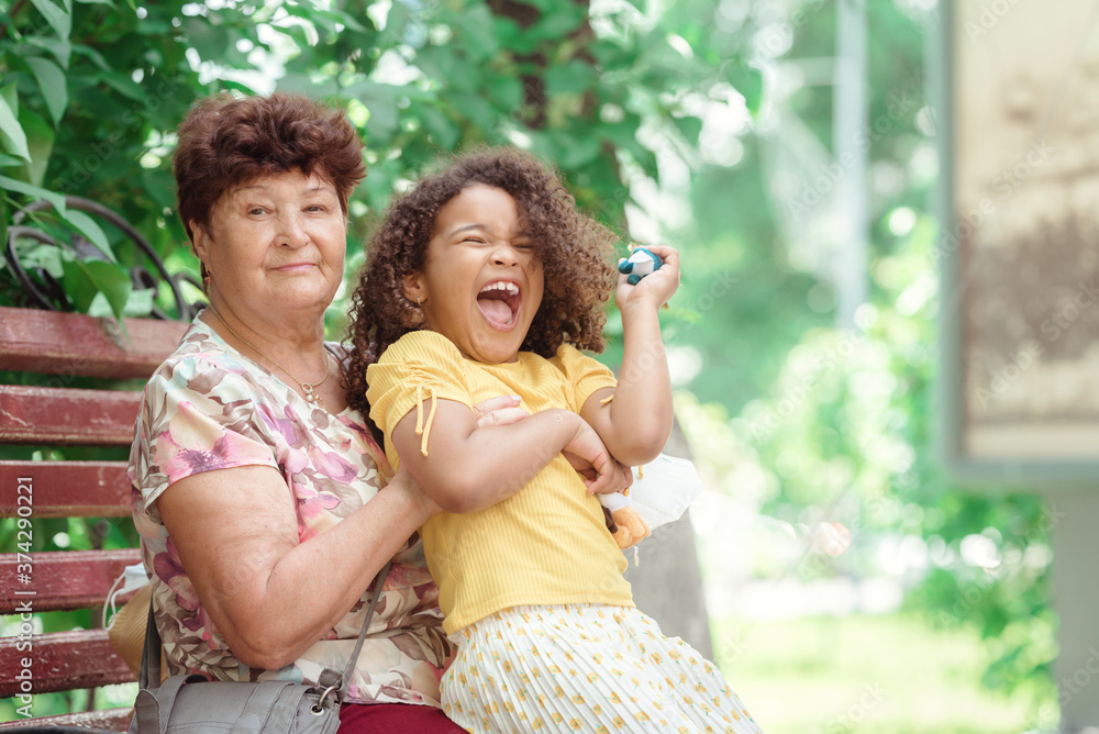 Fototapeta premium Smiling generations - portrait of grandmother with her daughter and grandchilld outdoor in nature.