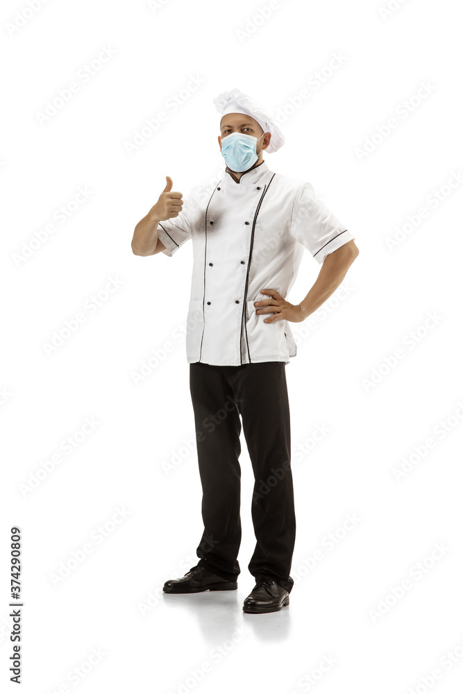Cooker, chef, baker in uniform and protective face mask isolated on white background. Young man, restaurant cooker's portrait. Business, foor, professional occupation, emotions concept. Copyspace for