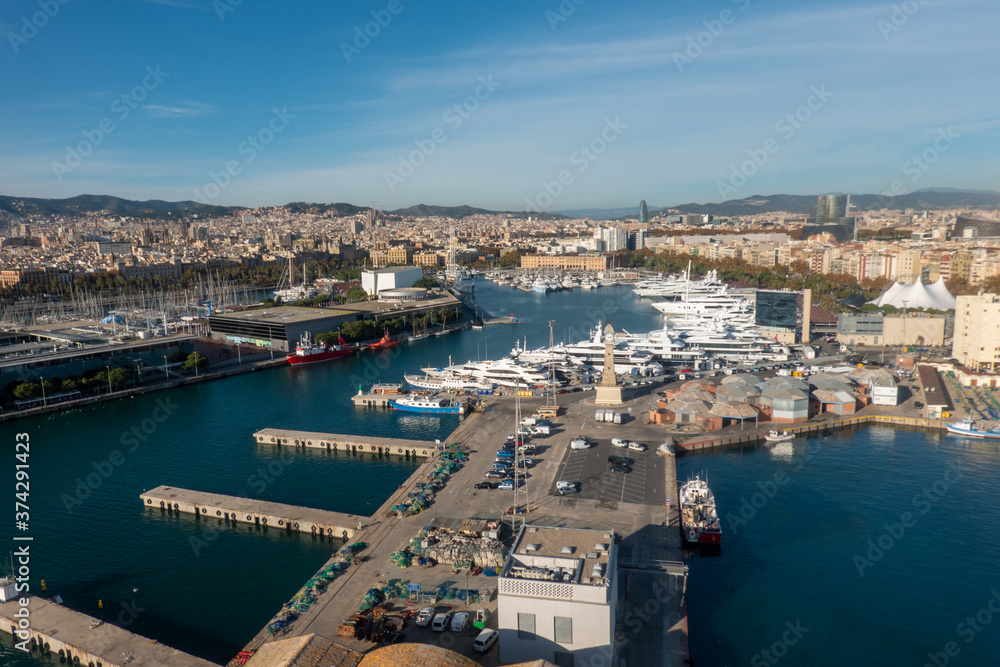 Cityscape of Barcelona with the port. Aerial view from the cable car that connects La Barceloneta beach to Montjuic hill. Catalonia, Spain