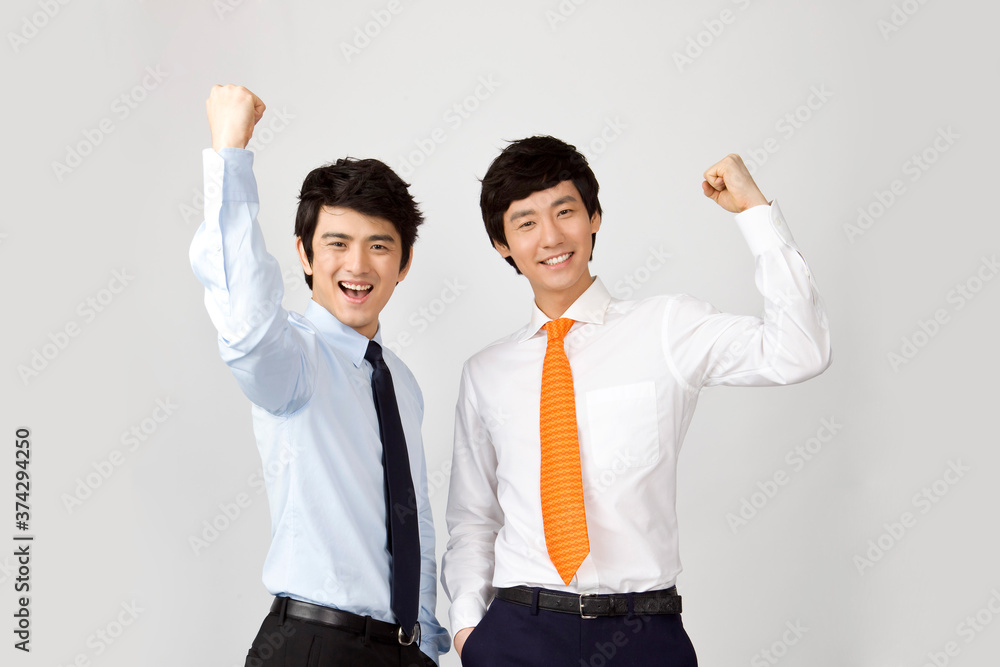 two businessmen celebrating success with a fist pump two businessmen celebrating success with a fist pump