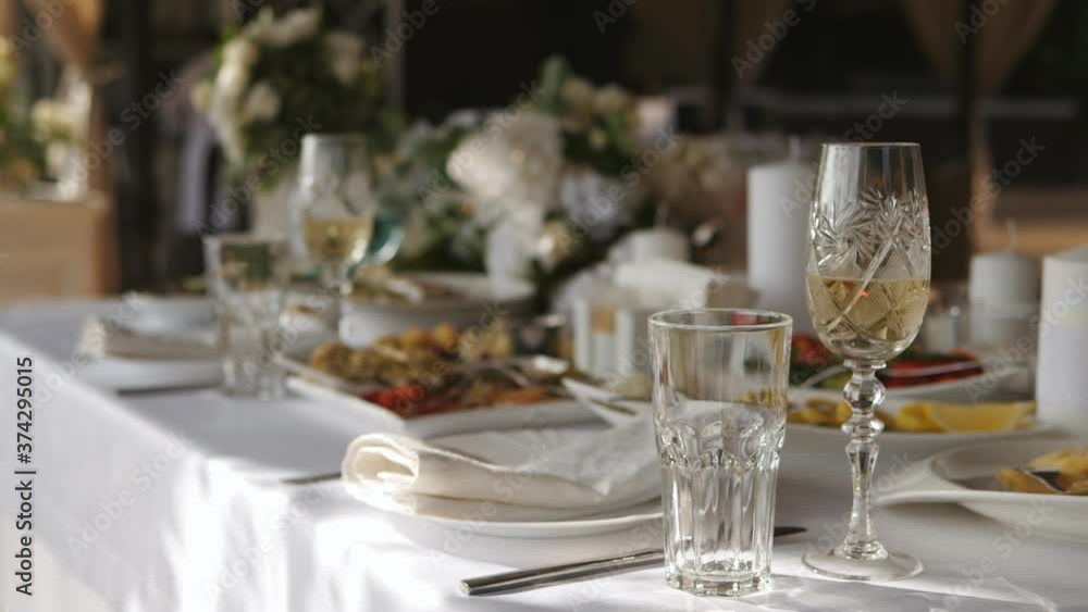 Close up view of served banquet table prepared for celebration. Made for wedding or engagement banquet there are glasses with champagne, juice, fruits, food and dishes prepared for eating beautifully Close up view of served banquet table prepared for celebration. Made for wedding or engagement banquet there are glasses with champagne, juice, fruits, food and dishes prepared for eating beautifully