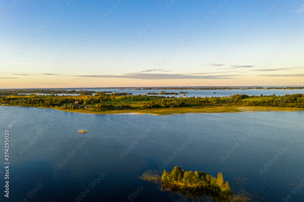 panoramic view of the lake with many islands on one of them there is an ancient temple made of wood at sunset filmed from a drone panoramic view of the lake with many islands on one of them there is an ancient temple made of wood at sunset filmed from a drone
