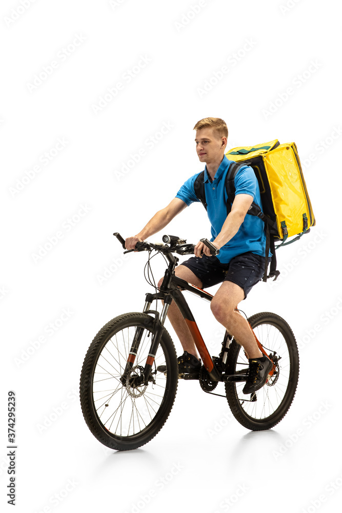Riding. Deliveryman with bicycle isolated on white studio background. Contacless service during quarantine. Man delivers food during isolation. Safety. Professional occupation. Copyspace for ad. Riding. Deliveryman with bicycle isolated on white studio background. Contacless service during quarantine. Man delivers food during isolation. Safety. Professional occupation. Copyspace for ad.